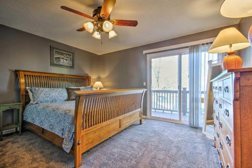 a bedroom with a bed and a ceiling fan at Bayview Lake House with Dock on Lake of the Ozarks in Lake Ozark