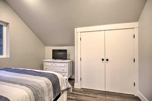 a bedroom with a bed and a white cabinet at Chic Farmhouse with Creek in Heart of Wine Country! in McMinnville