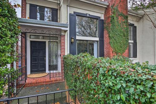 a brick house with a black door and a fence at Well-Appointed Condo Across Street from UC Davis! in Davis