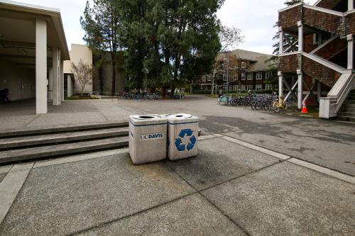 two trash cans sitting on the side of a street at Well-Appointed Condo Across Street from UC Davis! in Davis