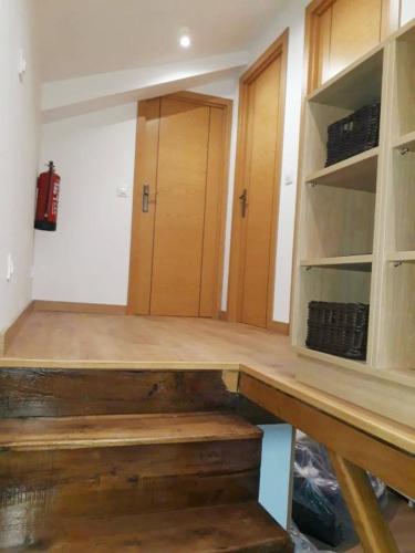 a room with wooden shelves and a wooden table at EL MEJICANO in Trevías