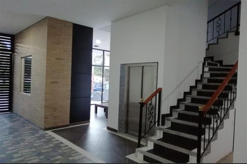 a hallway with a staircase in a house at Hotel Portal de los Andes in Bogotá