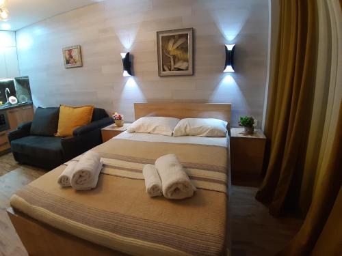 a hotel room with two beds and a couch at New Gudauri loft1 in Gudauri