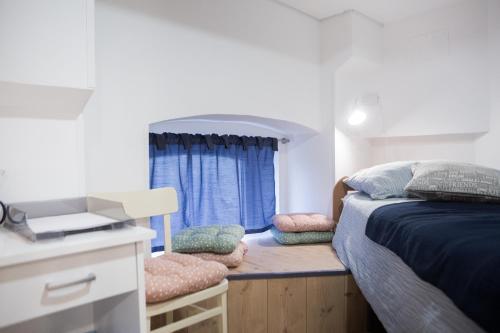 a small bedroom with a bed and a window at Stylish Apartment with Castle View & Free Parking in Ljubljana