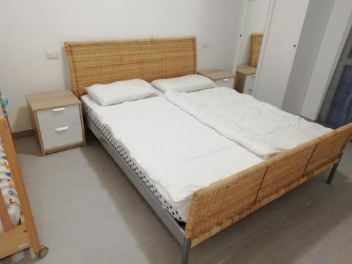 a bedroom with a bed and two night stands at Appartamento FIORE in Cannero Riviera