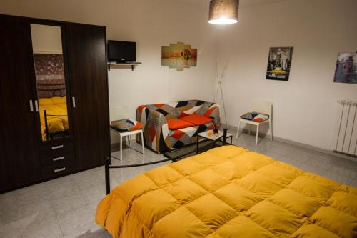 a bedroom with a bed and a chair in it at Casa Agorà in Palazzolo Acreide