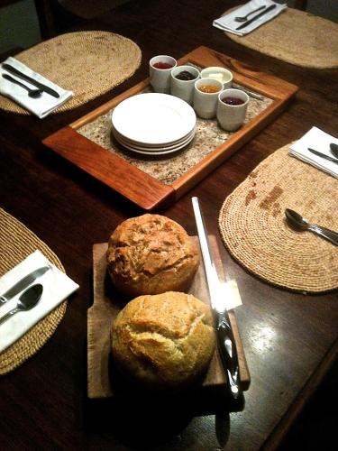 a wooden table with plates and bowls of food at Stone Hill Overlook in Hermann