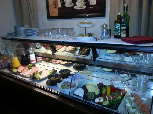 a display case filled with different types of food at Hotel Royal Hanau in Hanau am Main