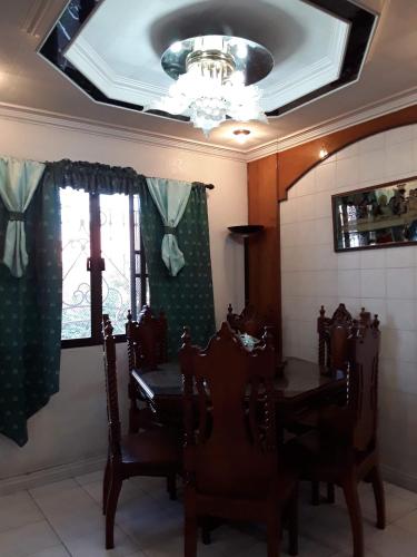 a dining room with a table and chairs and a ceiling at Fabuluz Luxury at Princess Place in Malolos