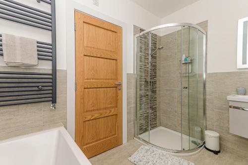 a bathroom with a shower and a glass door at Park View - 4 Star Luxury in Belfast