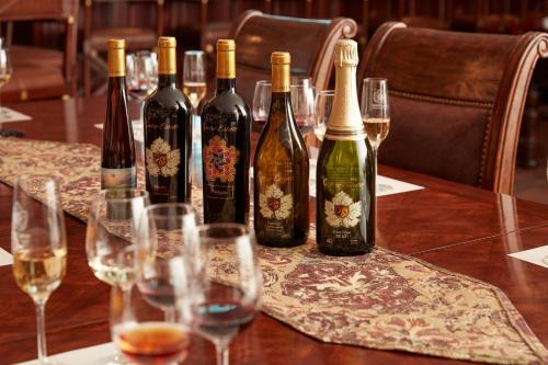 a group of wine bottles on a table with wine glasses at Carter Estate Winery and Resort in Temecula