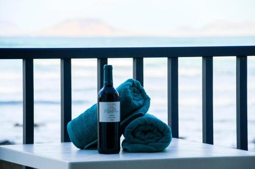 a bottle of wine and a stuffed animal on a rail at Seaview Famara 2 in Famara