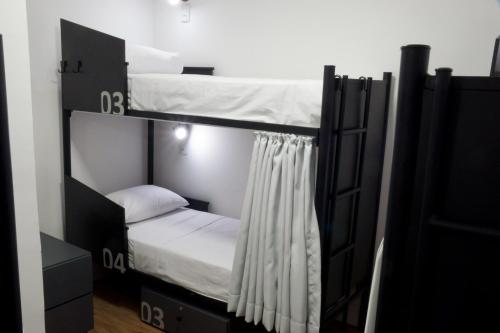 a couple of bunk beds in a room at Hostel More SP in Sao Paulo