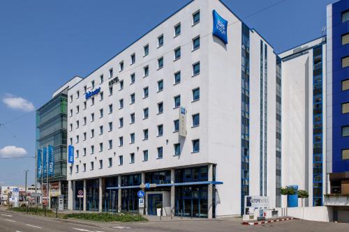 a large white building on the corner of a street at ibis budget Stuttgart City Nord in Stuttgart