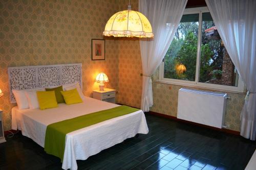 a bedroom with a bed with yellow pillows and a window at Apartment in Cala Gonone 26346 in Cala Gonone