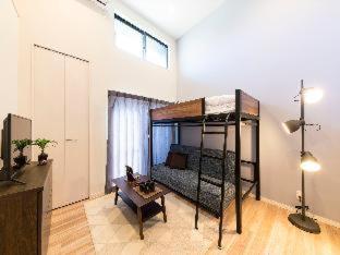 a room with a bunk bed and a table at TRIP POD MINOSHIMA A in Fukuoka