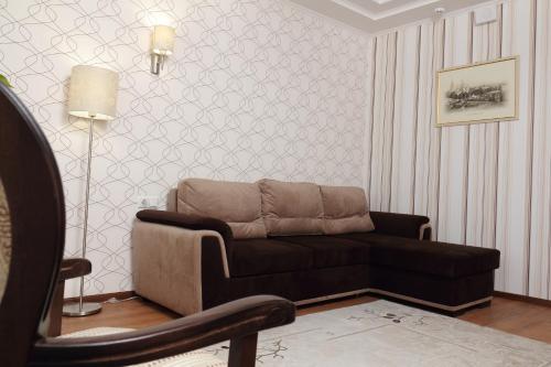 a living room with a couch and a chair at Hotel Aristokrat in Poltava