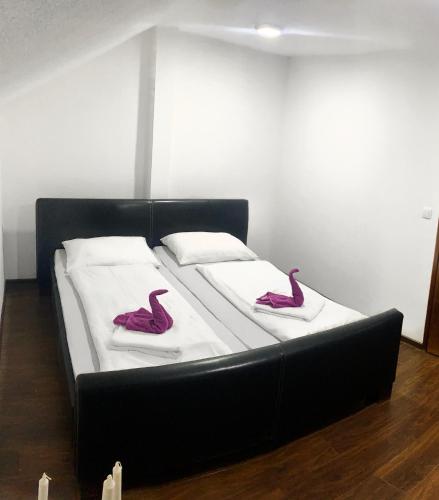 a bed with two pink flamingos on top of it at Modern Apartment in Brčko