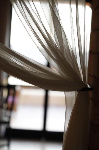 a close up of a window with white curtains at Skyline in Mitzpe Ramon