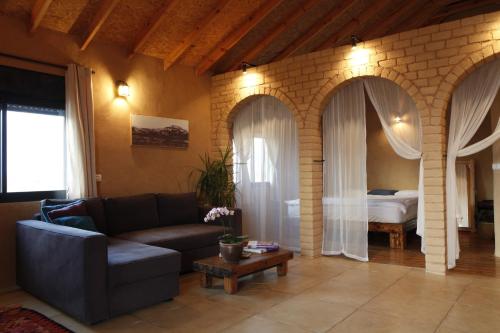 a living room with a couch and a bed at Skyline in Mitzpe Ramon