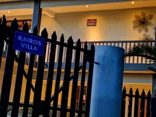 a black fence with a blue street sign on it at Kairos Villa in Seremban
