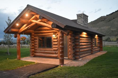 a log cabin with a black roof at Kodiak Mountain Resort in Afton