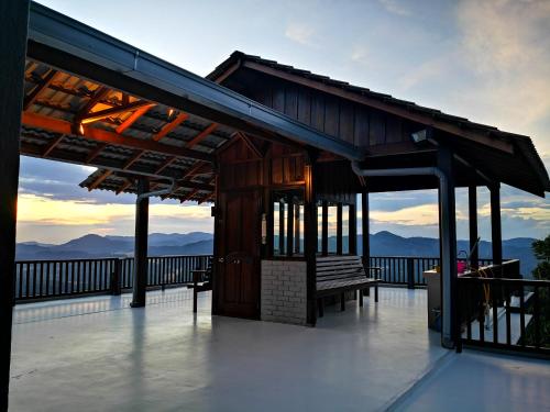 a building with a bench on top of a deck at Kairos Villa in Seremban