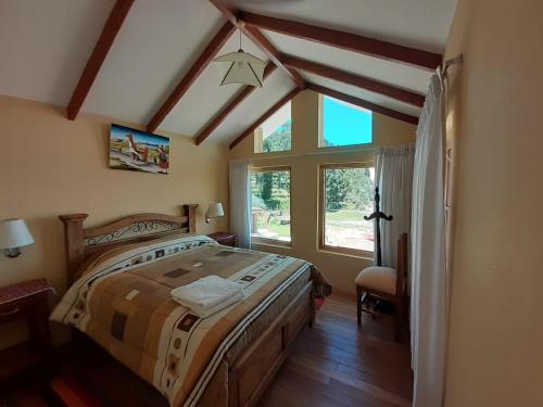 a bedroom with a bed and a large window at JACHA INTI in Isla de Sol