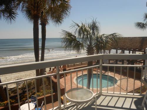 a view of the beach from the balcony of a resort at 0105 Waters Edge Resort condo in Myrtle Beach