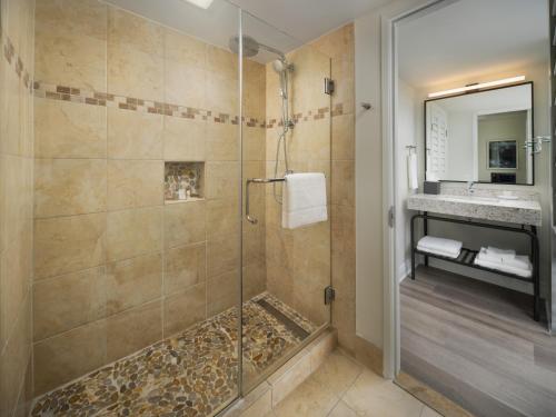 a bathroom with a shower stall and a sink at Hotel Indigo San Diego Del Mar, an IHG Hotel in San Diego