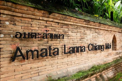 a brick wall with the wordsania laneacy on it at Amata Lanna Chiang Mai, One Member of the Secret Retreats in Chiang Mai