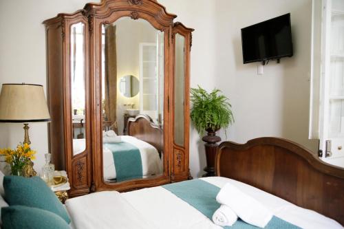 a bedroom with a large mirror and a bed at Casa Turin in Mexico City