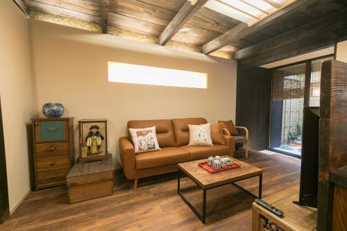 a living room with a couch and a table at Nishodo Machiya HIKARU GOJO in Kyoto