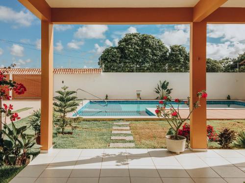a view of a pool from the patio of a house at Mansão Beberibe in Beberibe