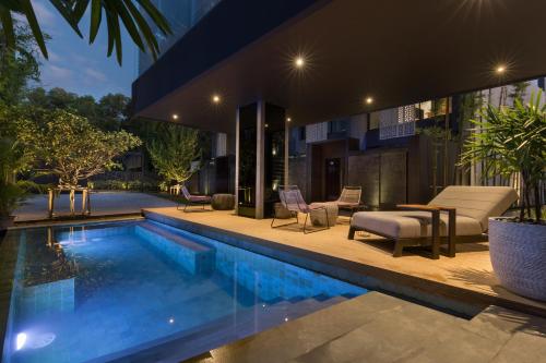 a swimming pool in the backyard of a house at Villa Kyoto in Layan Beach