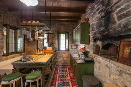 a kitchen with a stone wall and a stone oven at Liodentro - Olea in Plataria