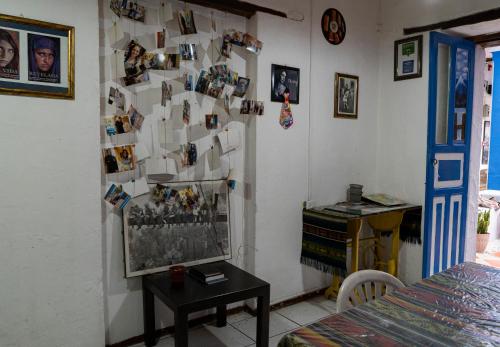 a room with a wall with pictures on it at Blue Door Housing Historic Quito in Quito