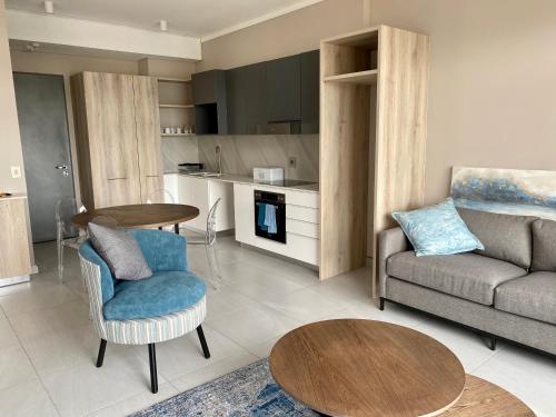 a living room with a couch and a table at Menlyn Maine Residence 11th Floor Apartment in Pretoria