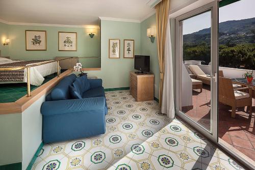 a hotel room with a bed and a living room at Hotel Continental Ischia in Ischia