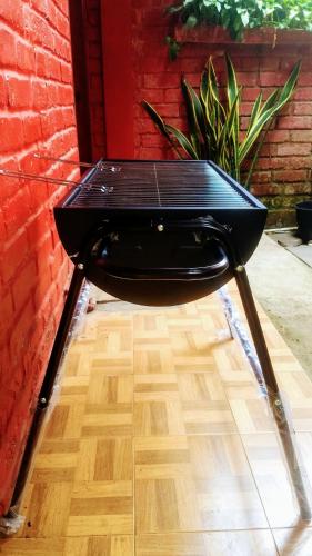 a black table sitting on top of a wooden floor at Oemah Kajoe Lembang in Lembang