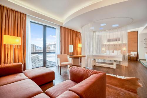 a living room with a couch and a piano at Radisson Blu Resort Bukovel in Bukovel