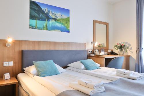 a hotel room with two beds and a mirror at Hotel Bystra in Białka Tatrzanska