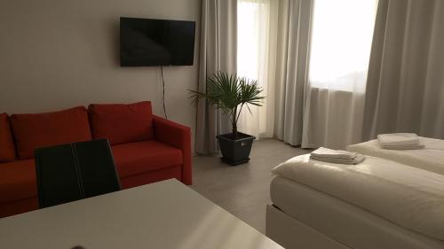 a living room with a couch and a tv at 305 Berlin, Studio Apartment, 38m2 2-4 Pers in Klagenfurt