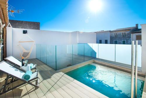 a swimming pool on the roof of a house at Owl Booking Villa Miquel - Luxury Retreat in Búger