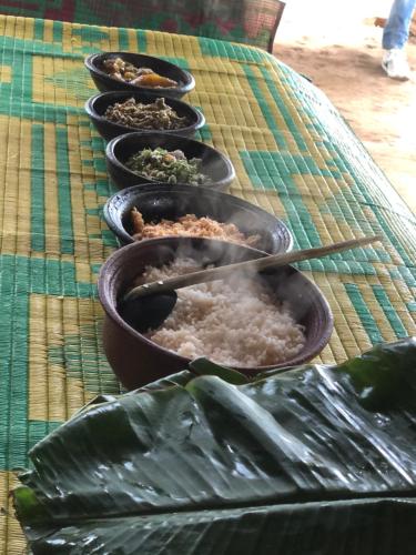 a group of bowls of food on a table at Kandyan Lounge in Kiribatkumbura