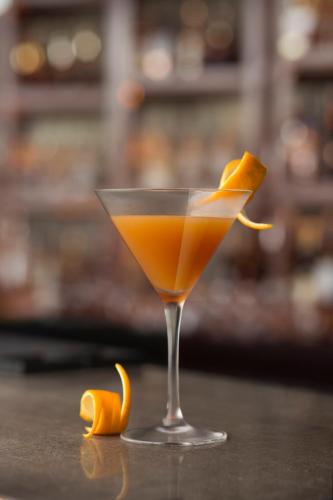 an orange drink in a glass with an orange peel at Taj Palace, New Delhi in New Delhi