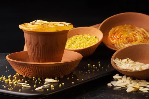 a group of bowls of food on a black plate at Taj Palace, New Delhi in New Delhi
