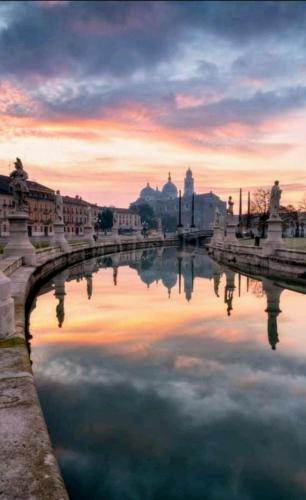 a bridge over a river in a city at sunset at Villa Stefania in Noventa Padovana