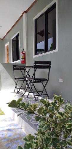 a bench sitting in front of a building with windows at GREENSPACE in Panglao