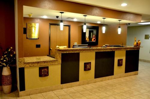 a lobby with a reception counter in a hospital at Days Inn by Wyndham Mesquite Rodeo TX in Mesquite